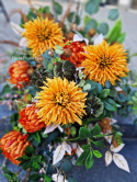 A large tombstone with red and orange chrysanthemum