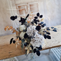 Tombstone decoration in a basket with black poppies and hydrangea and artichokes