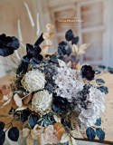 Tombstone decoration in a basket with black poppies and hydrangea and artichokes