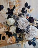 Tombstone decoration in a basket with black poppies and hydrangea and artichokes